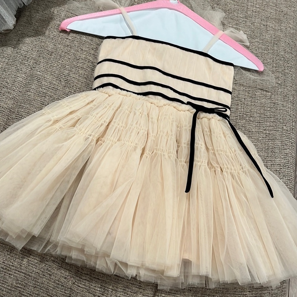 Ivory crinoline dress with black bow trim